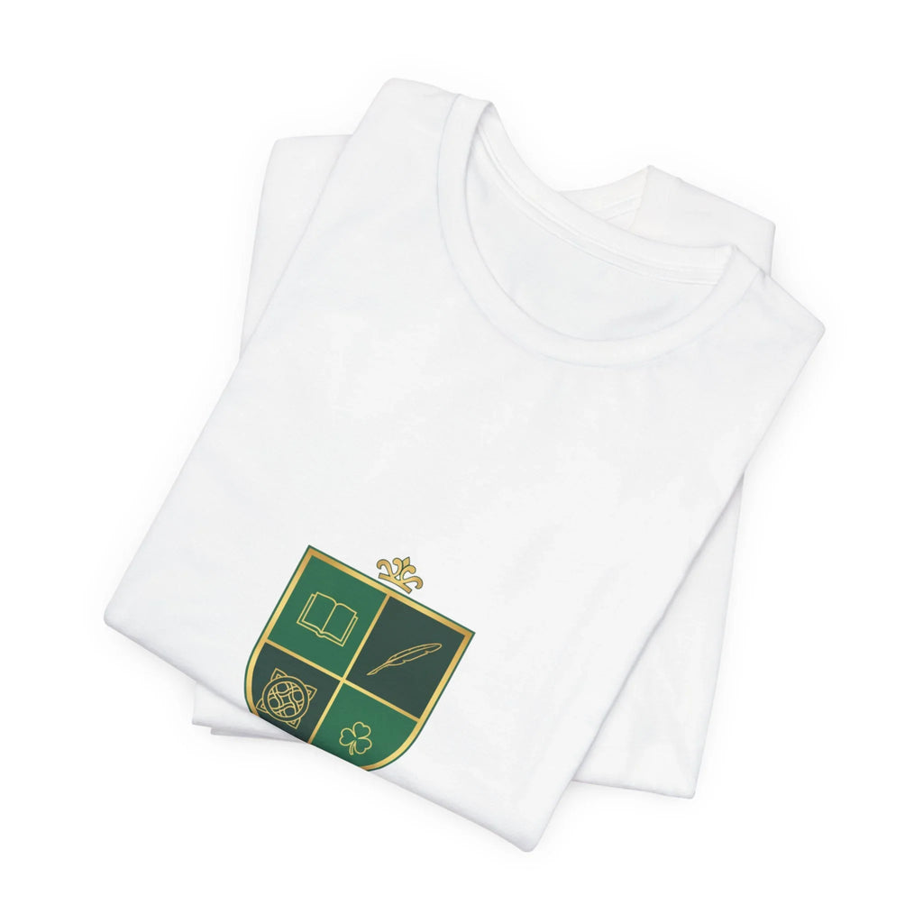 Folded white t-shirt with green and gold crest emblem design, featuring a book, quill, knot, and clover.